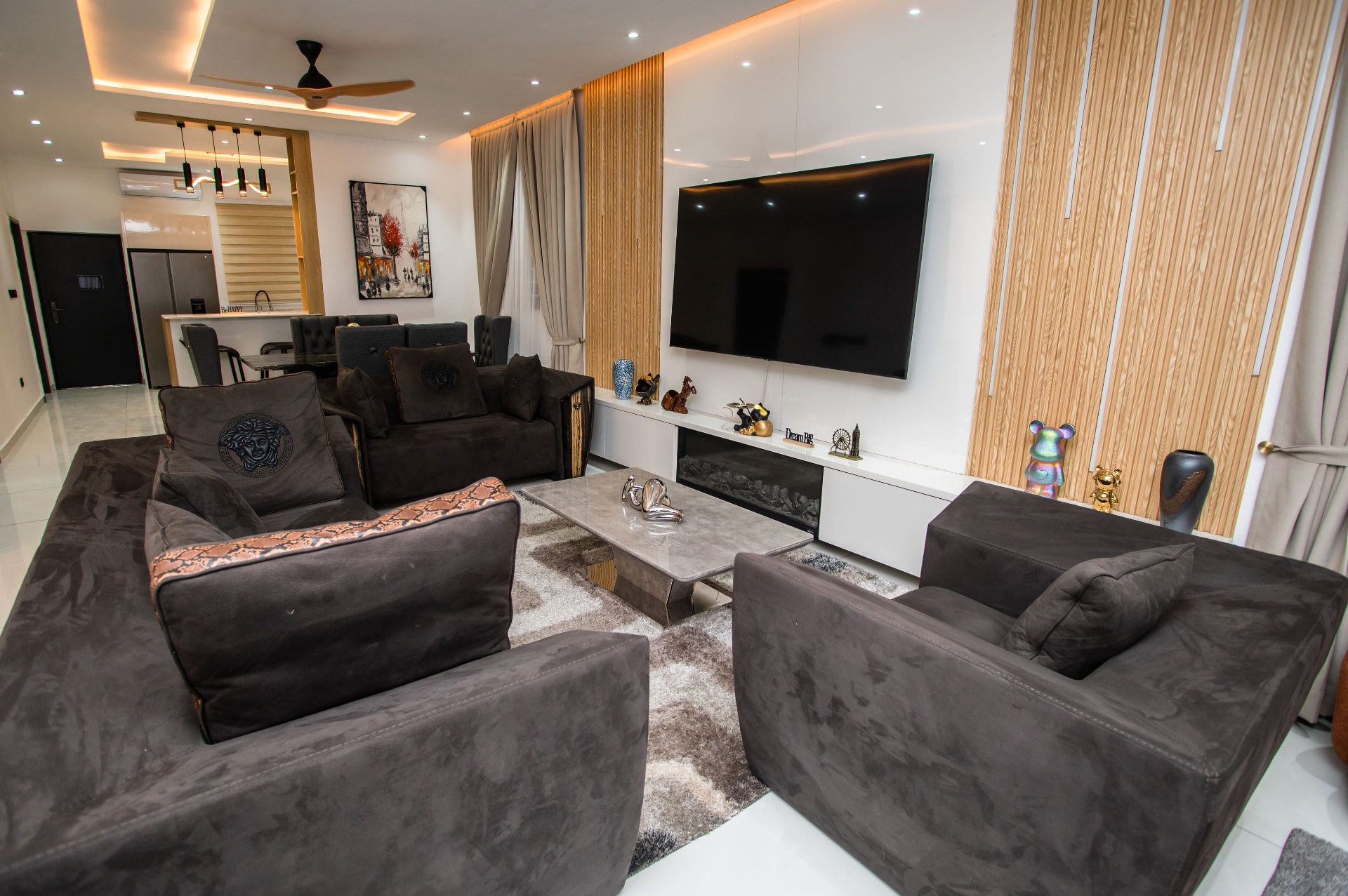 Living room with fluted timber wall at Pryse Enclave
